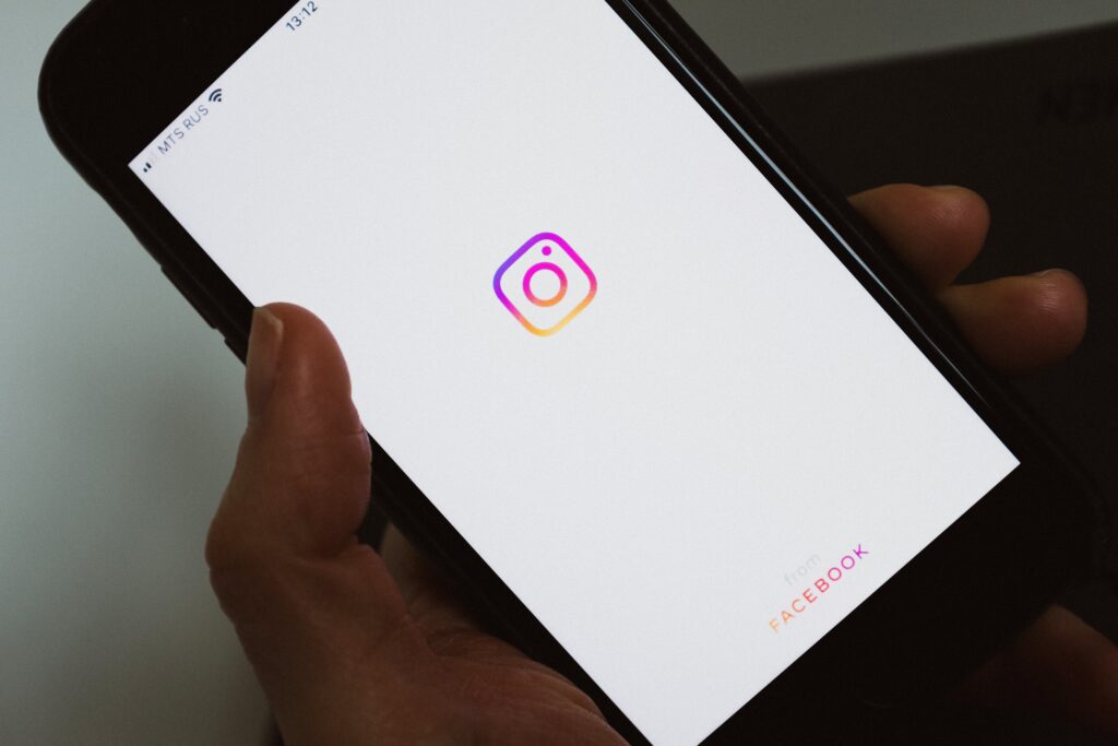 image of person holding phone opening the instagram app