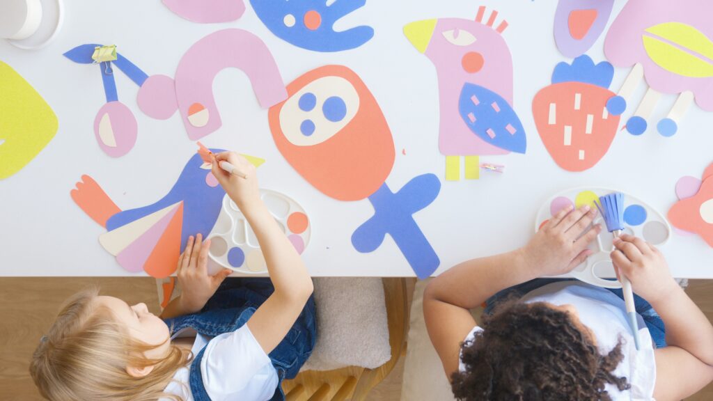 image of two kids painting together 