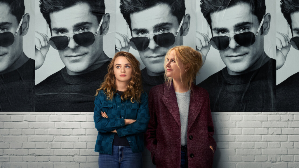 Joey King and Nicole Kidman for Netflix film 'A Family Affair', posing in front of posters of Zac Efron's character